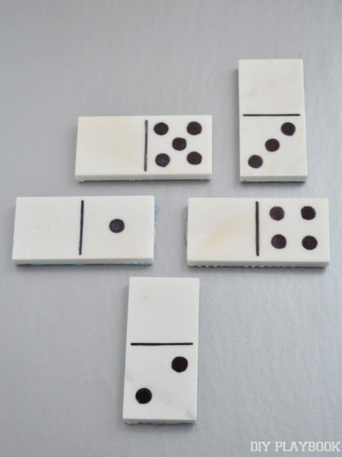 Draw on any design using the sharpie onto the blank marble tiles to make domino pieces. 