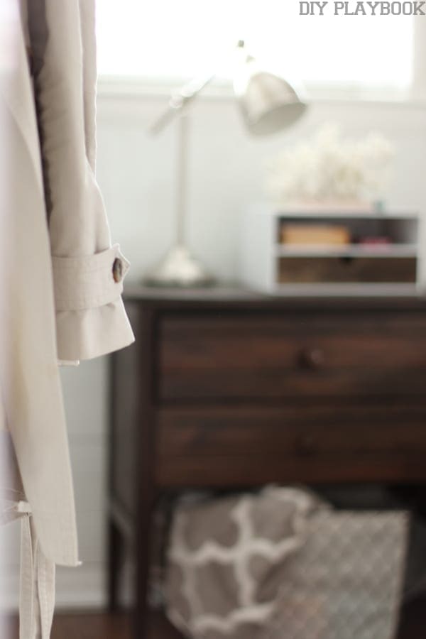 This dark stained nightstand pairs well with the silver lamp. 