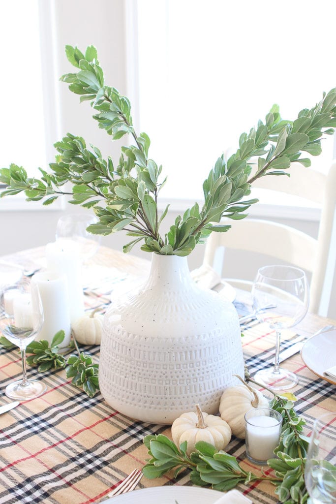 Add fresh greenery to a white vase