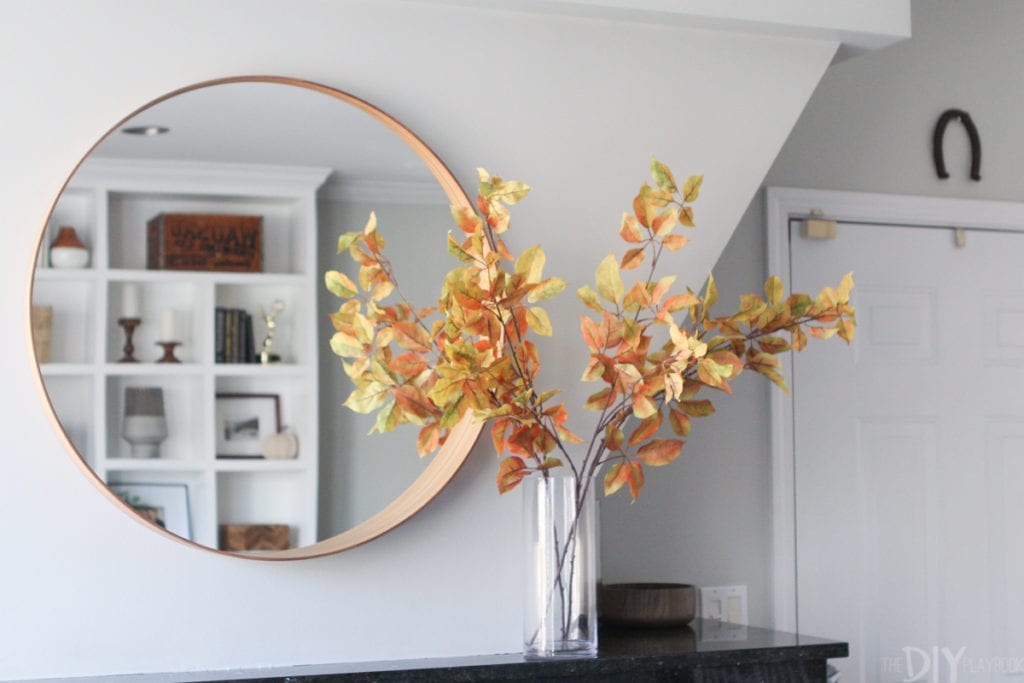 Clear vase with fall leaves and branches