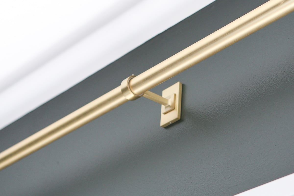 Gold curtain rod on a dark wall