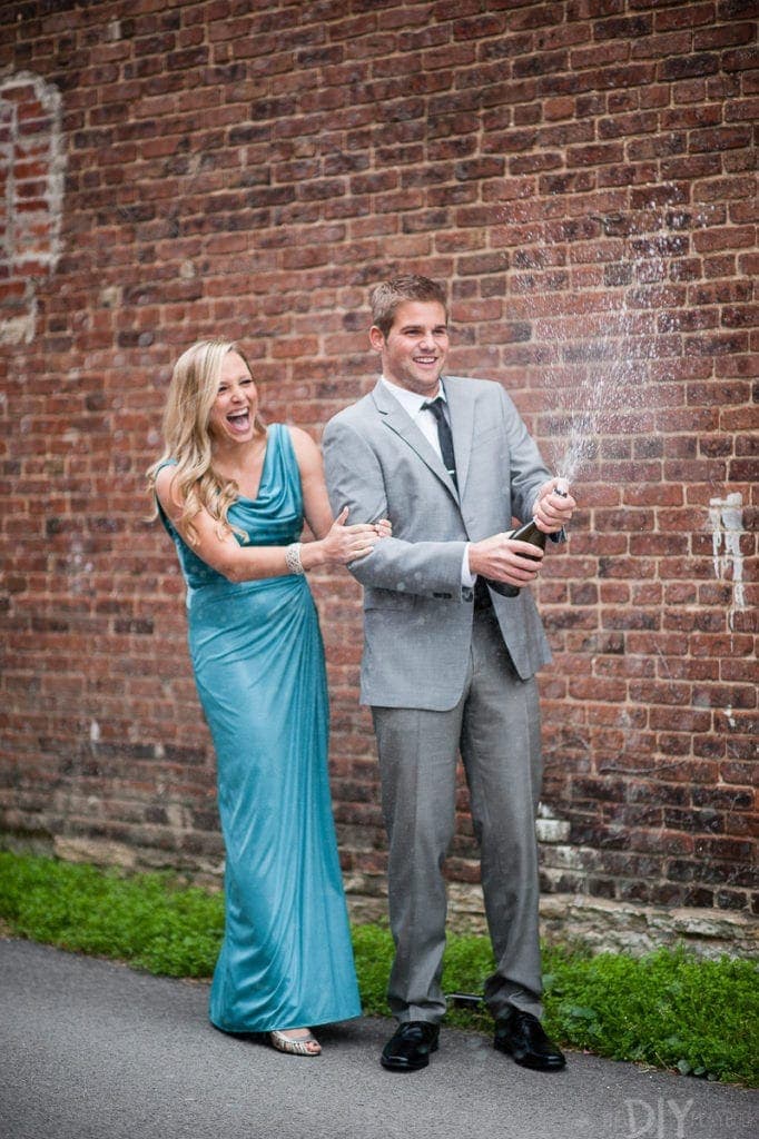 Spraying champagne engagement photos