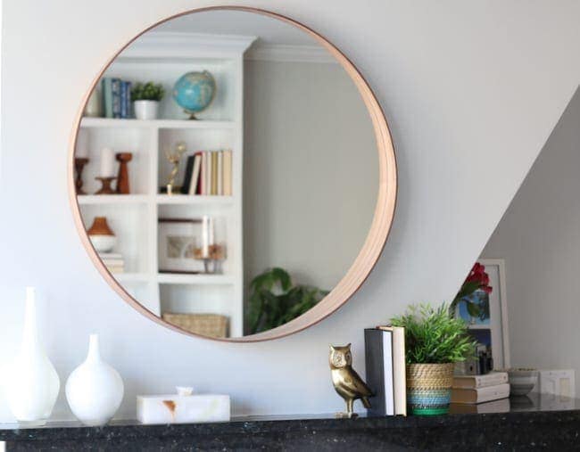 This circular mirror over the fireplace is a modern addition.