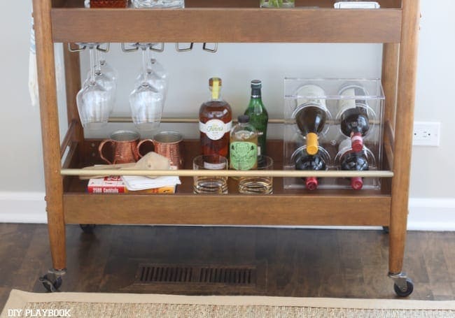 The wood bar cart pairs well with the floors. 