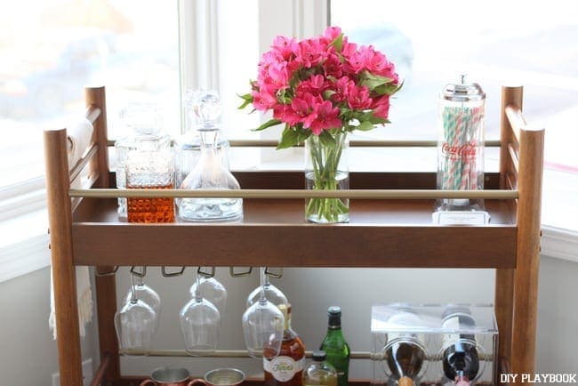 The natural light shines beautifully onto the bar cart. 