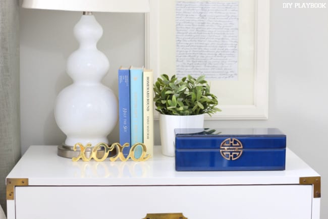 Nightstand with gold accent pieces. 