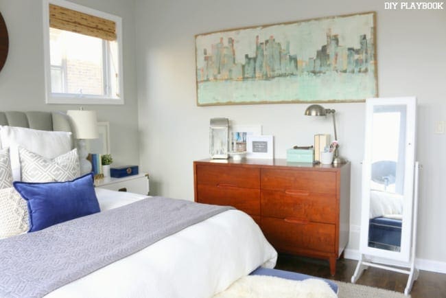 Master bedroom after makeover with white accents and grey walls. 