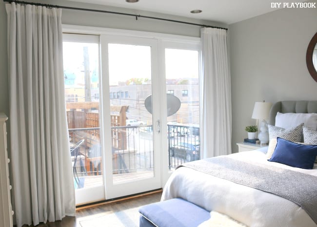 Master bedroom with balcony and sliding doors. 