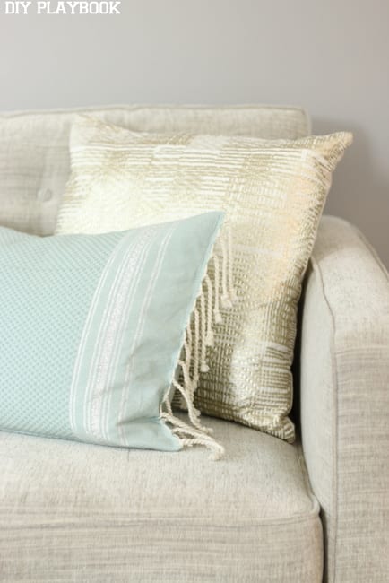 Soft colored throw pillows look beautiful on a greige couch.