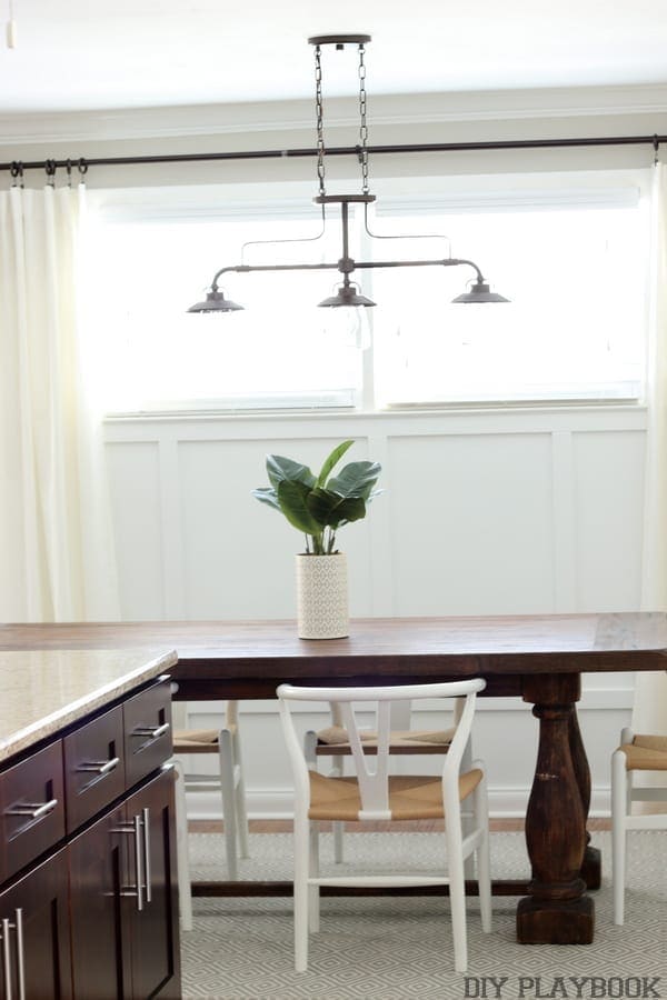 Industrial light fixture above the dining room table. 