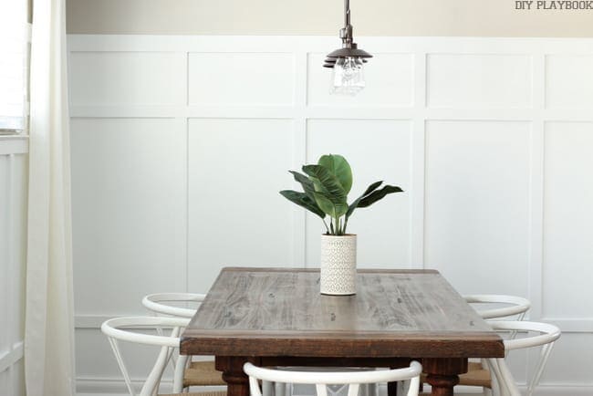 Dining Room with board and batten walls and a brown table. 