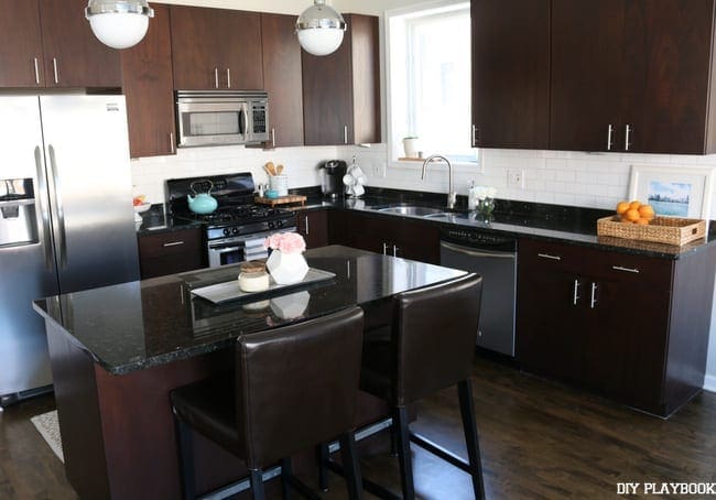 The kitchen subway tile backsplash is complete! I love the white tile with the dark cupboards and floor. 