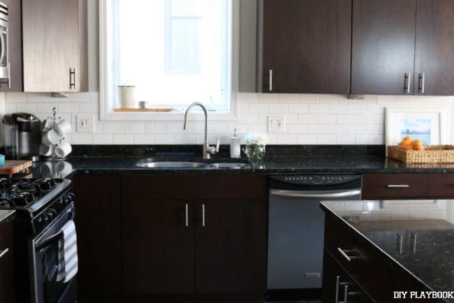 Here's the kitchen sink area after we installed the White Subway Tile Backsplash| DIY Playbook