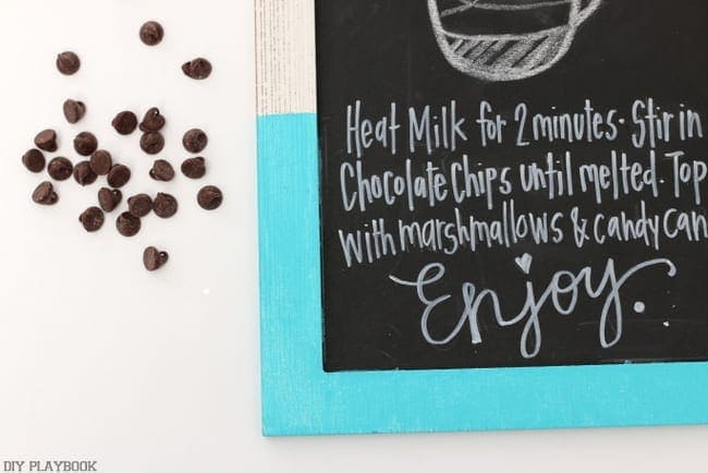 Chalkboard sign, hot cocoa recipe, mini chocolate chips. 