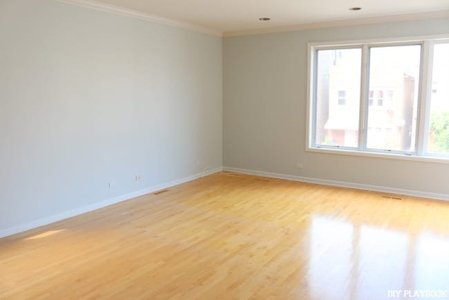 Our new home started out with these shiny, yellow hardwood floors prior to our renovation.