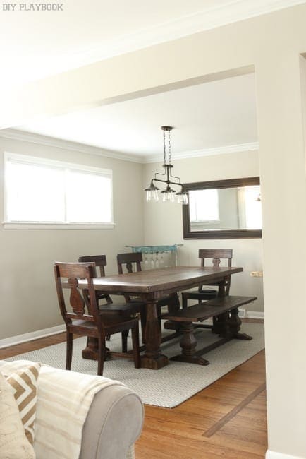 Dining room before the makeover with white walls and a dark table. 